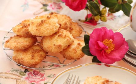 Fresh baked coconut macaroons ready to serve with a camellia.